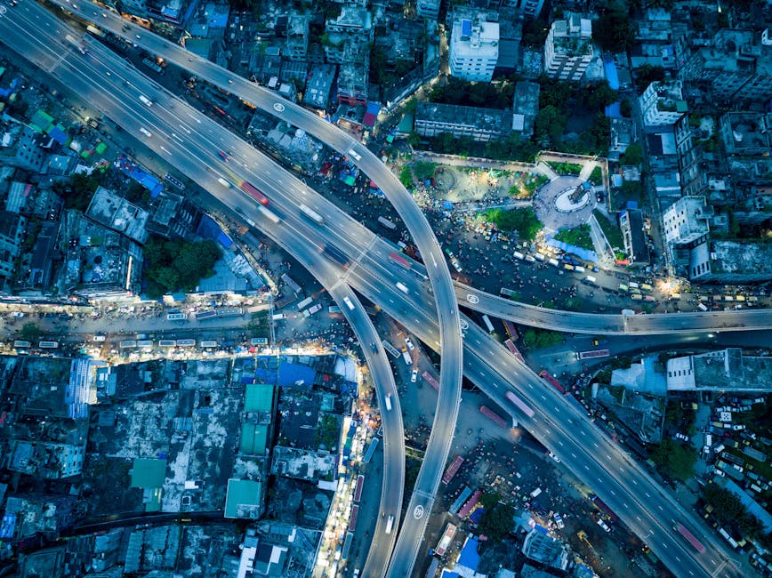 Stunning aerial shot of a bustling city highway interchange captured at twilight.